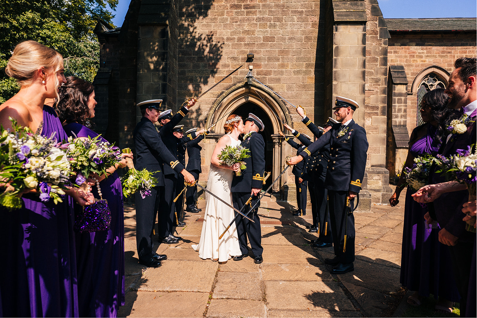 Derby DIY Farm Wedding Photography - the bride and groom stopped by the swords and kiss
