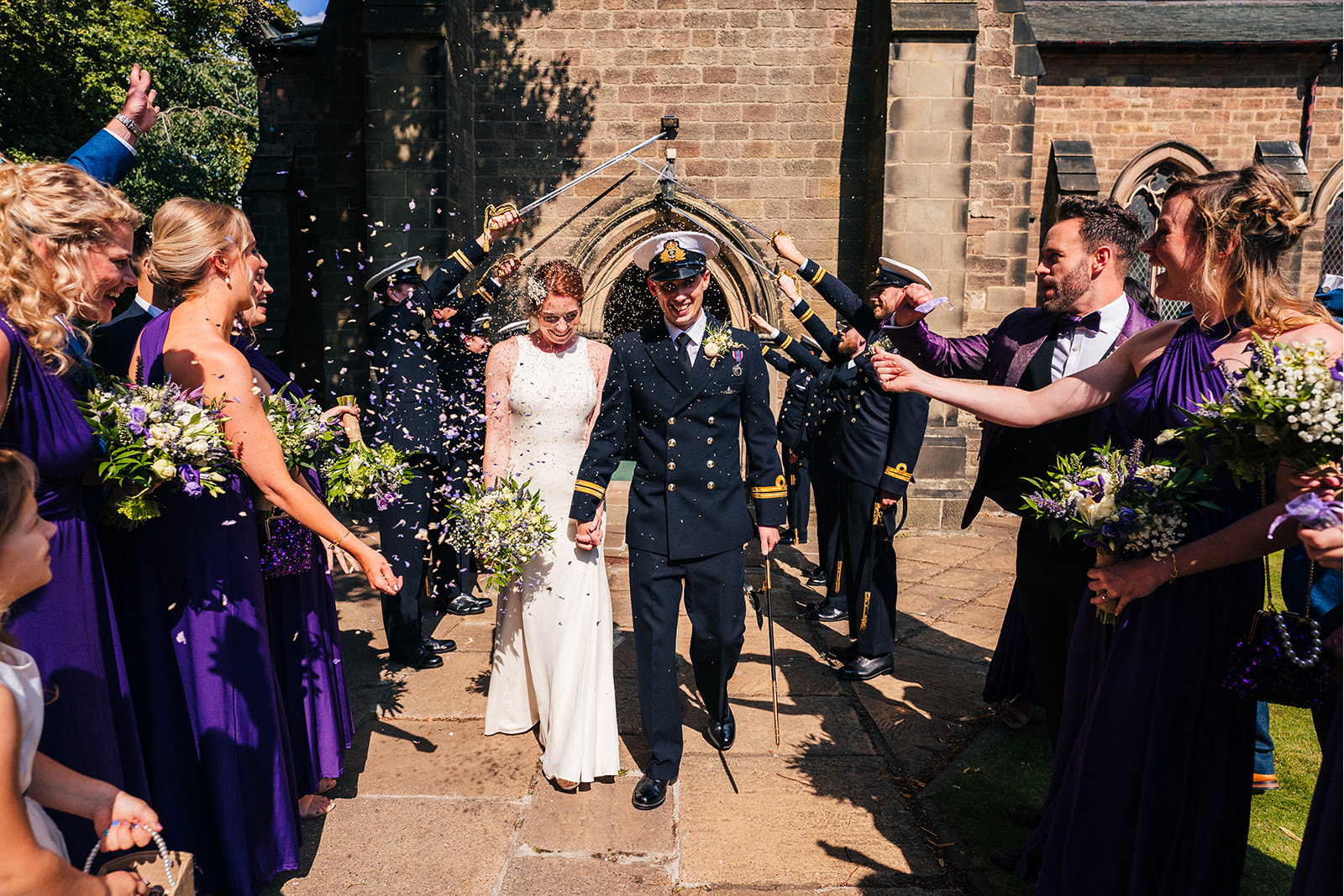 Derby DIY Farm Wedding Photography - the bride and groom walking through the confetti
