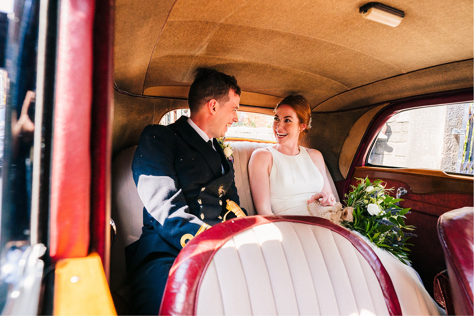 Derby DIY Farm Wedding Photography - bride and groom looking at each other and smiling in the Wedding car
