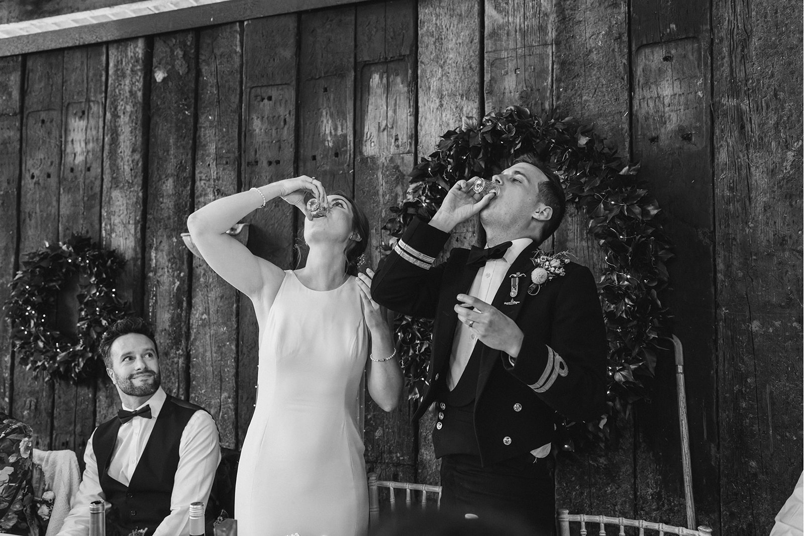 Derby DIY Farm Wedding Photography - the bride and groom share a shot of whiskey to celebrate their wedding
