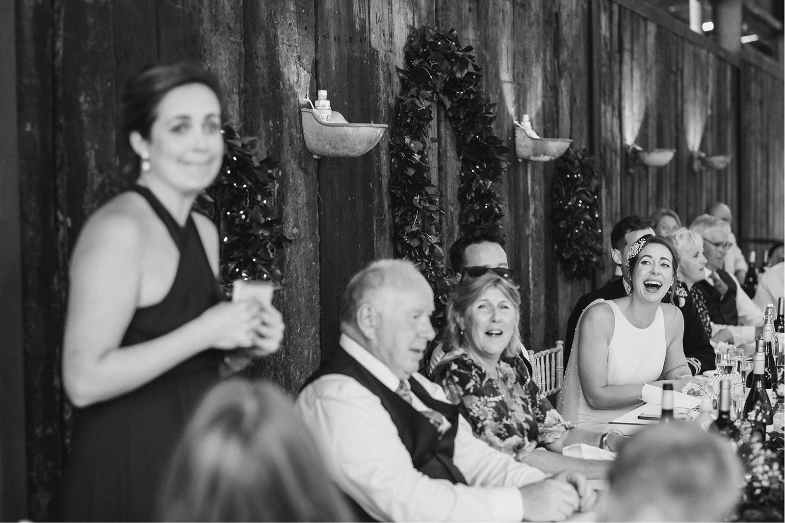 Derby DIY Farm Wedding Photography - the bride laughing at her sisters wedding speech
