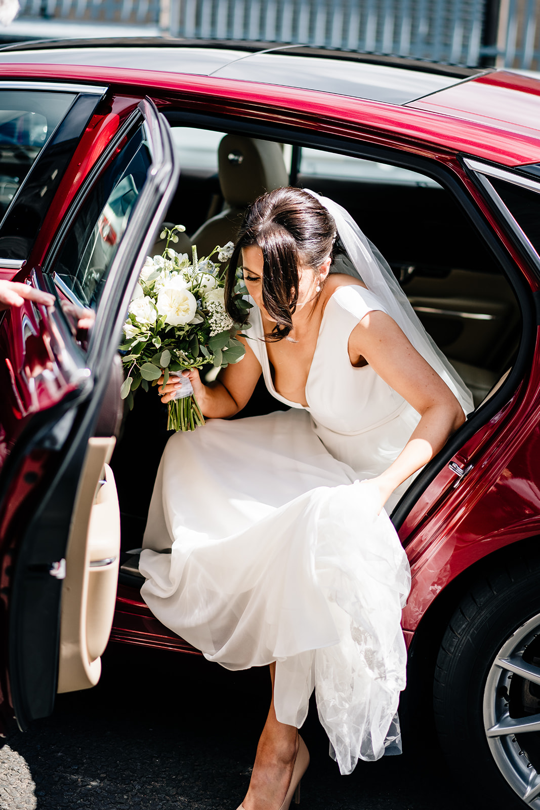 bride getting out the wedding car for the big day