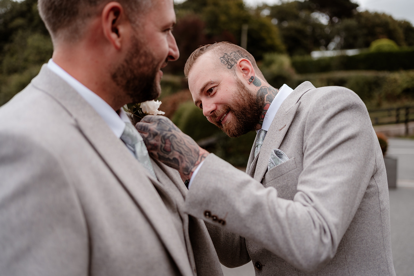 Best man pins buttonhole on groom at a Sandy Cove Hotel wedding
