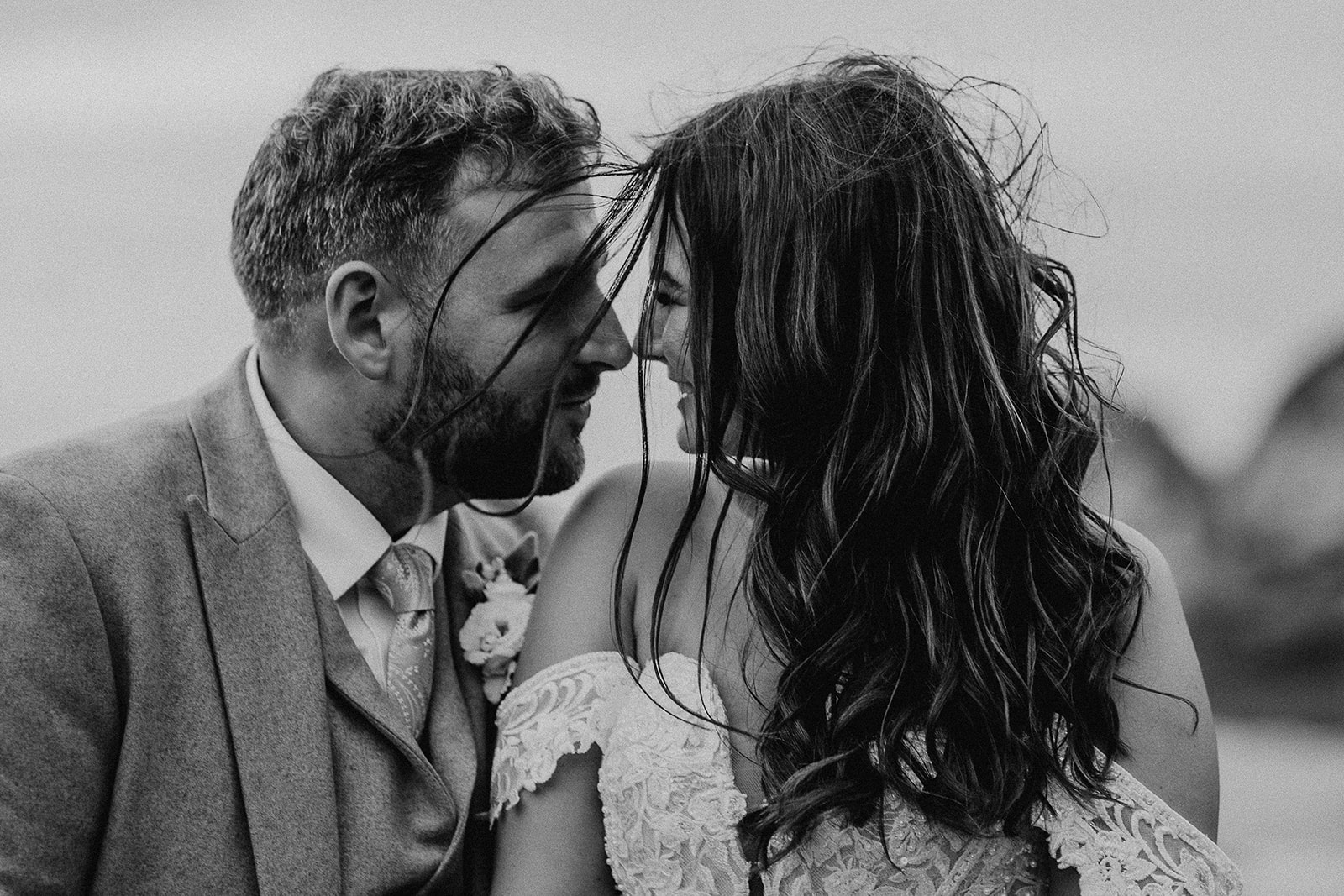 Black and white photos of bride and groom with their heads close together at their Sandy Cove Hotel wedding