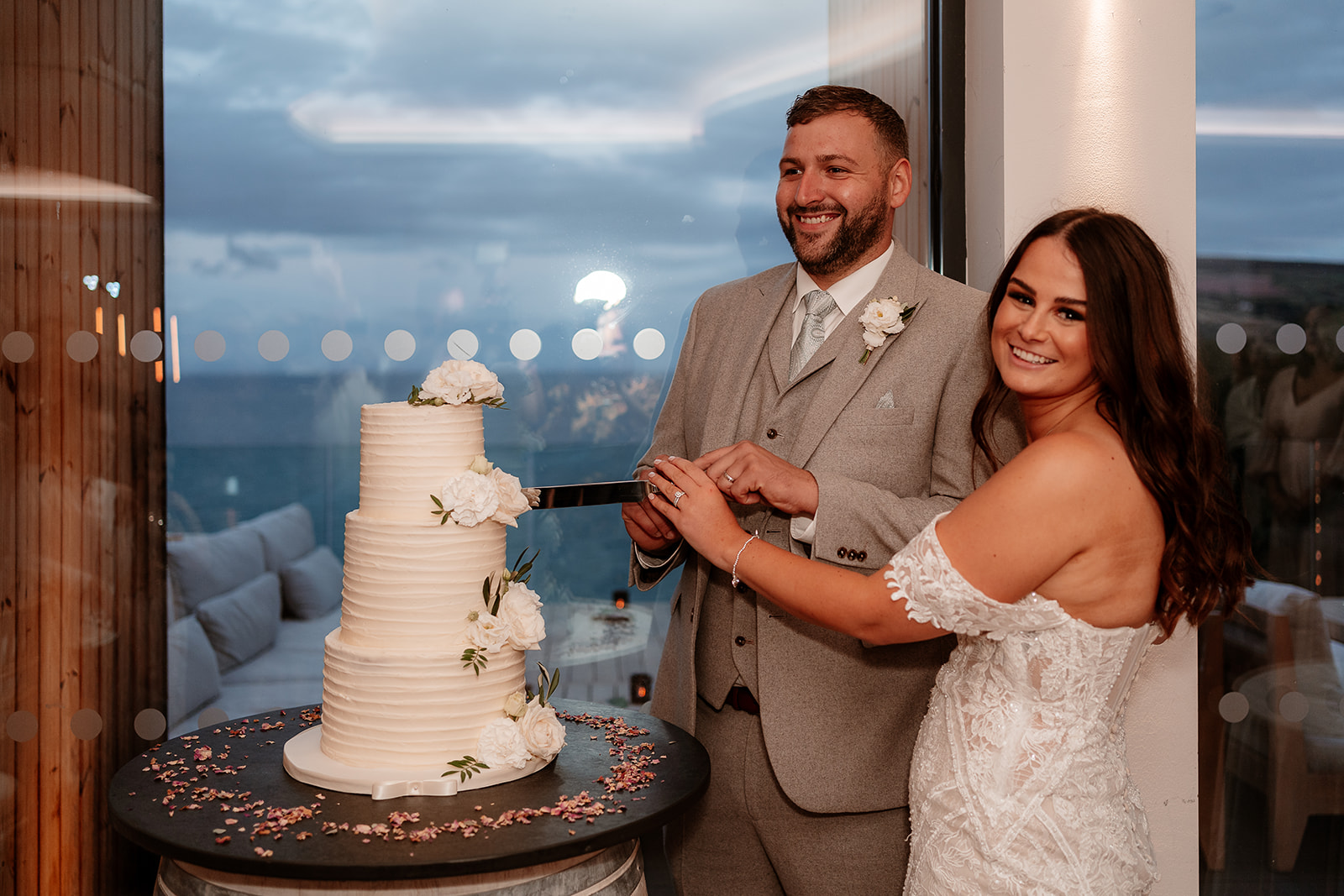 Bride and groom cut their cake at their Sandy Cove Hotel wedding