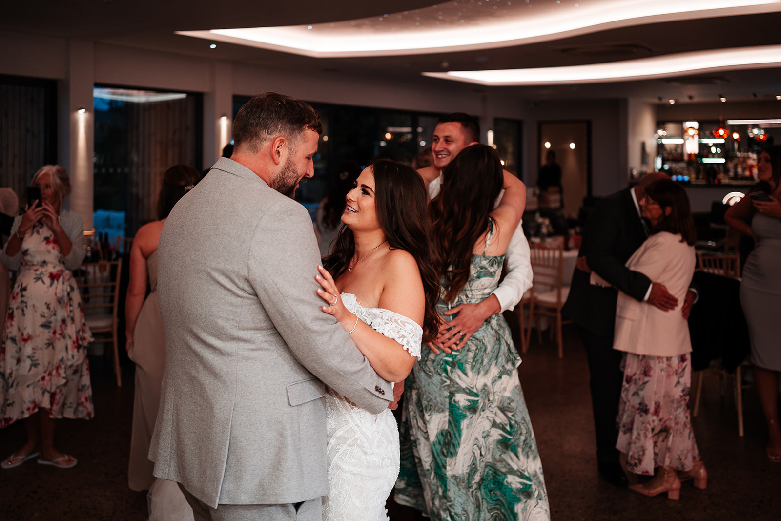 Bride and groom laugh together while dancing at their Sandy Cove Hotel wedding