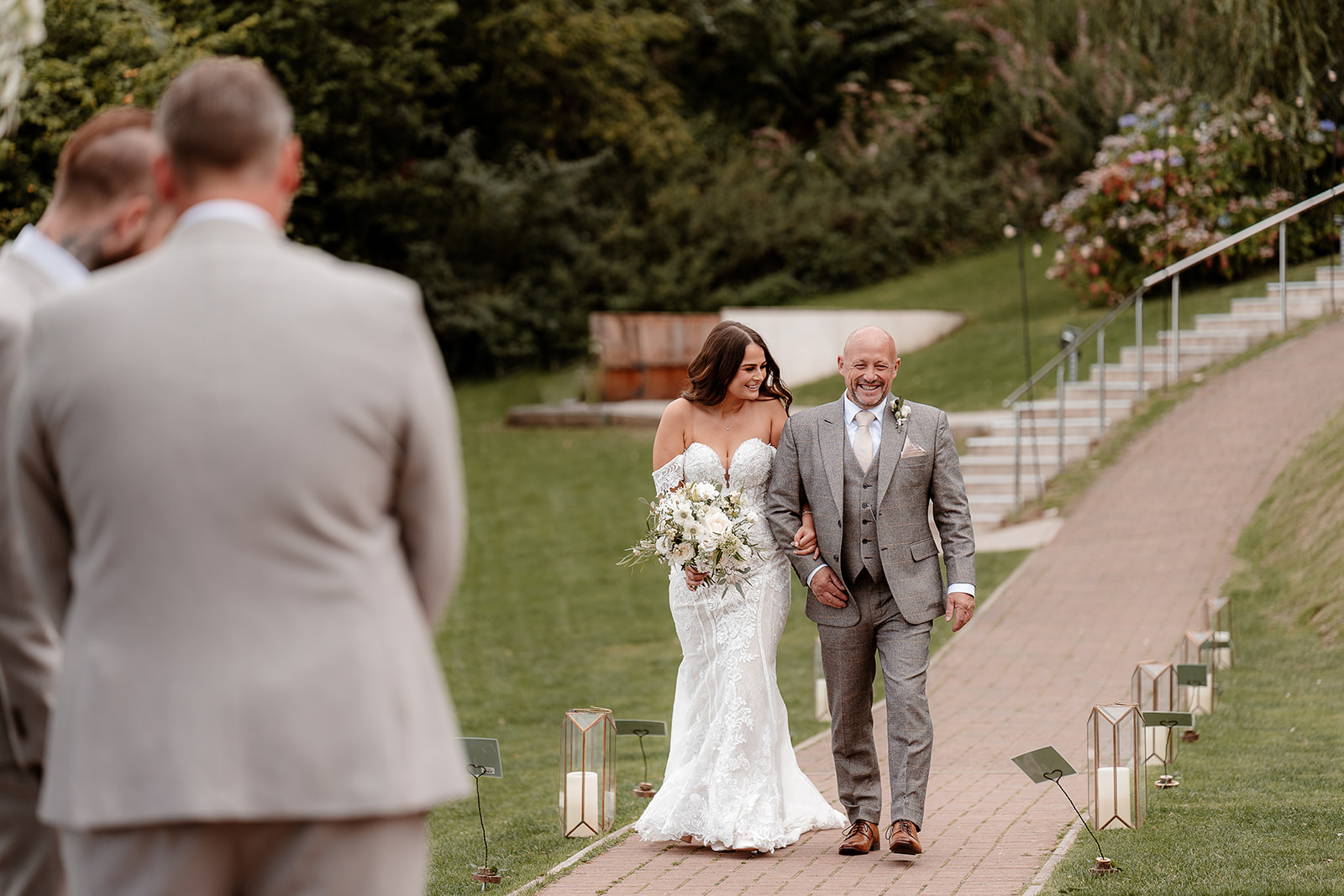 Bride and her father walk down the aisle to her outdoor ceremony for her Sandy Cove Hotel wedding