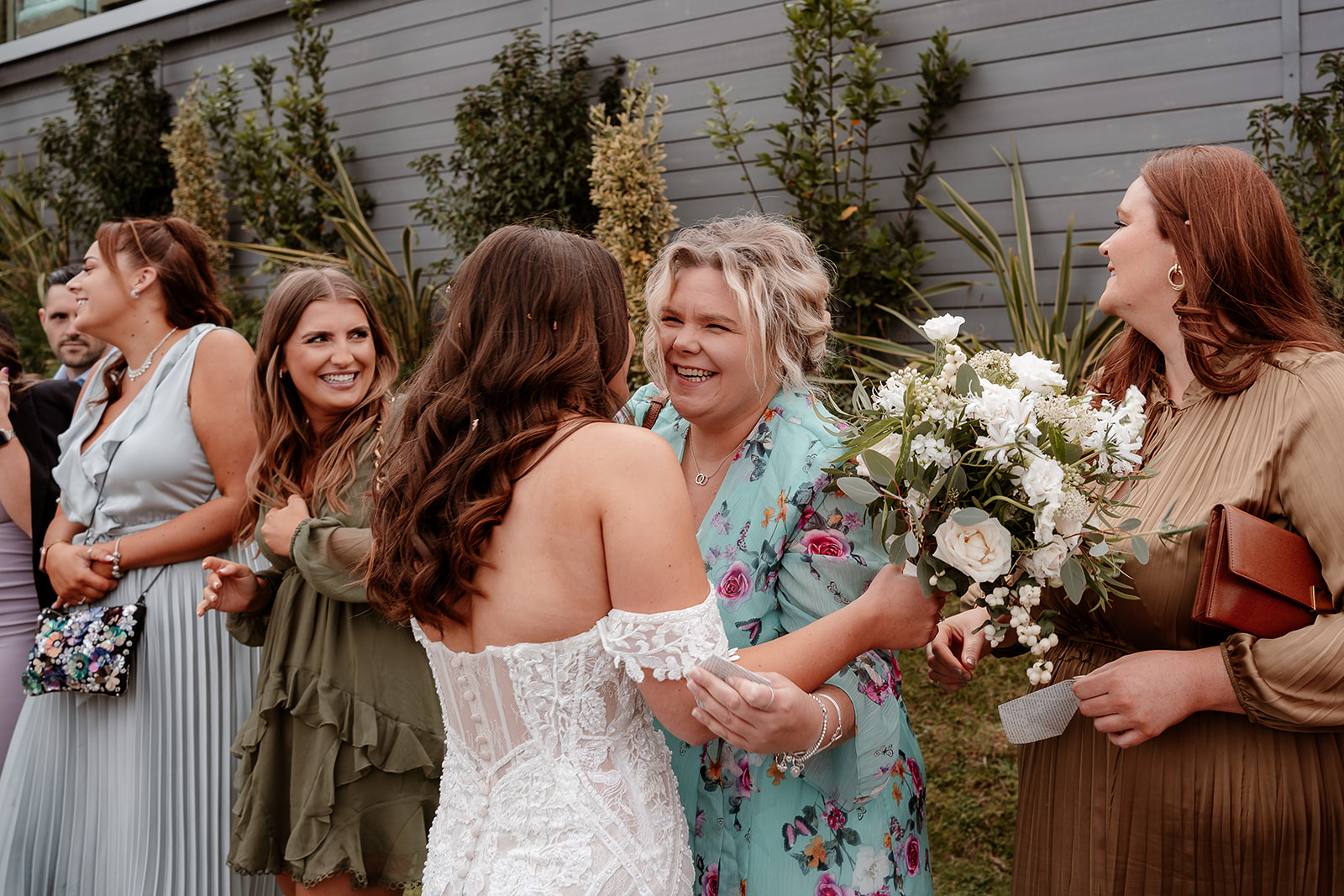 a bride hugs one of her guests at her Sandy Cove Hotel wedding