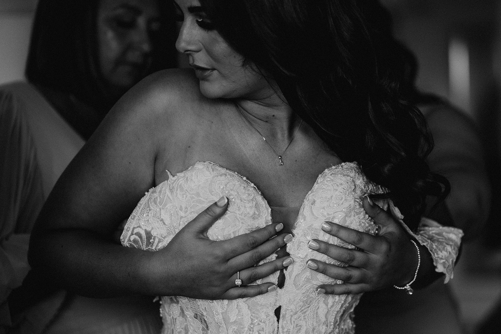 close up of bride putting on her wedding dress at a Sandy Cove Hotel wedding