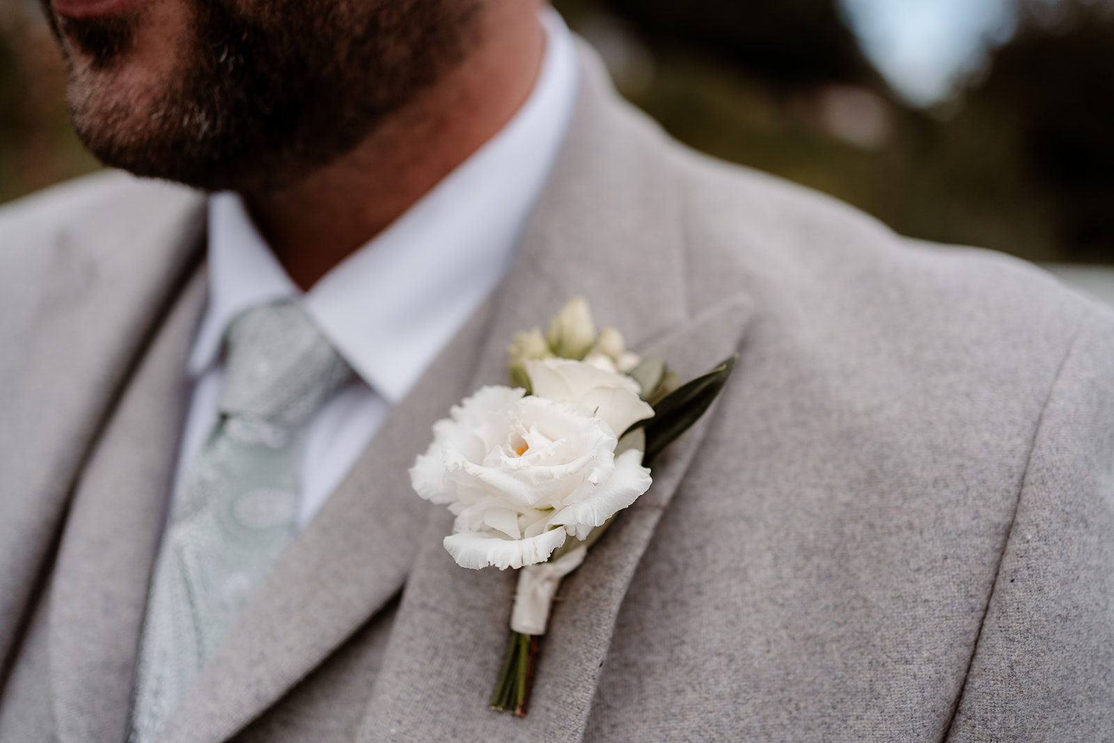groom's lapel with white flower buttonhole at a Sandy Cove Hotel wedding