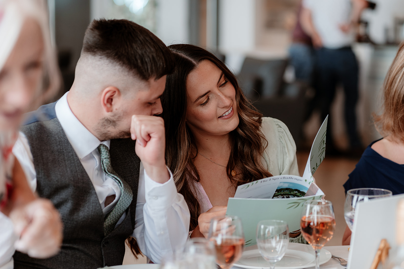 Guests look together at a wedding activity book while at a Sandy Cove Hotel wedding