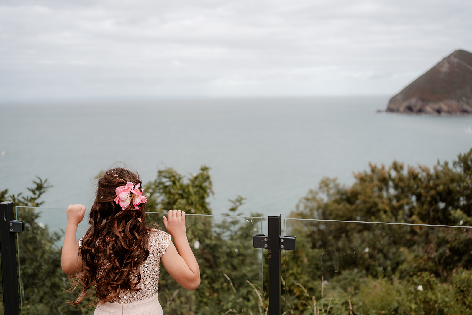 A little girl looks out over the view at a Sandy Cove Hotel wedding