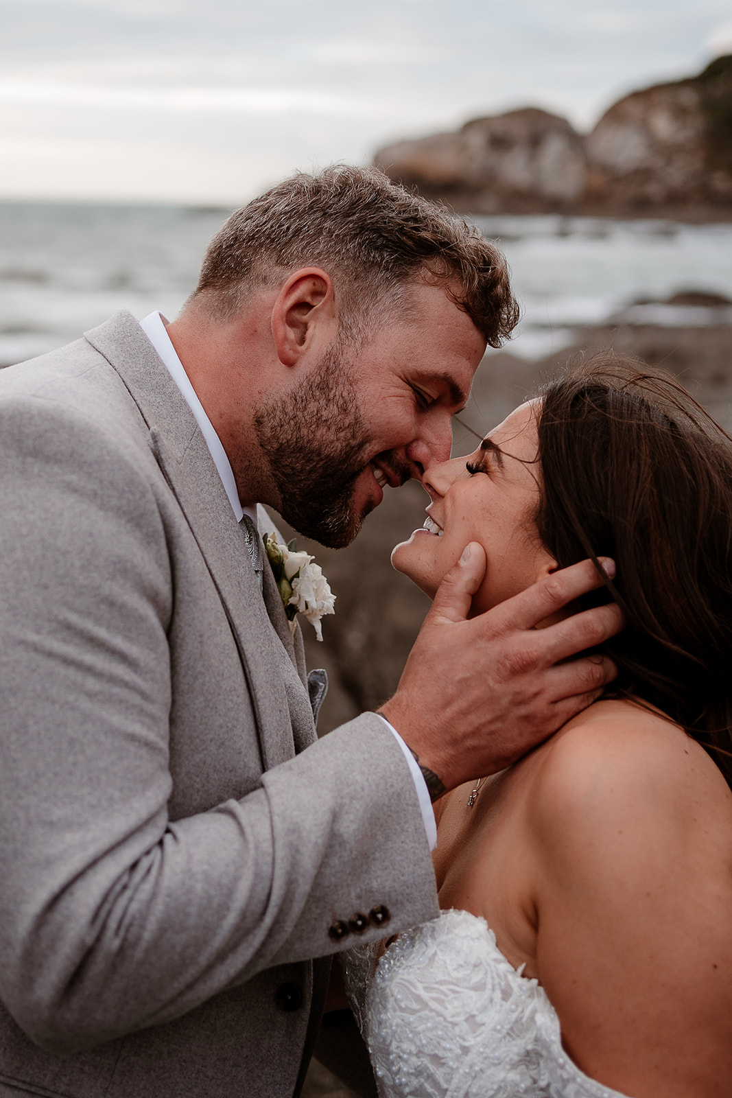 Portrait of the groom kissing his bride at their Sandy Cove Hotel wedding