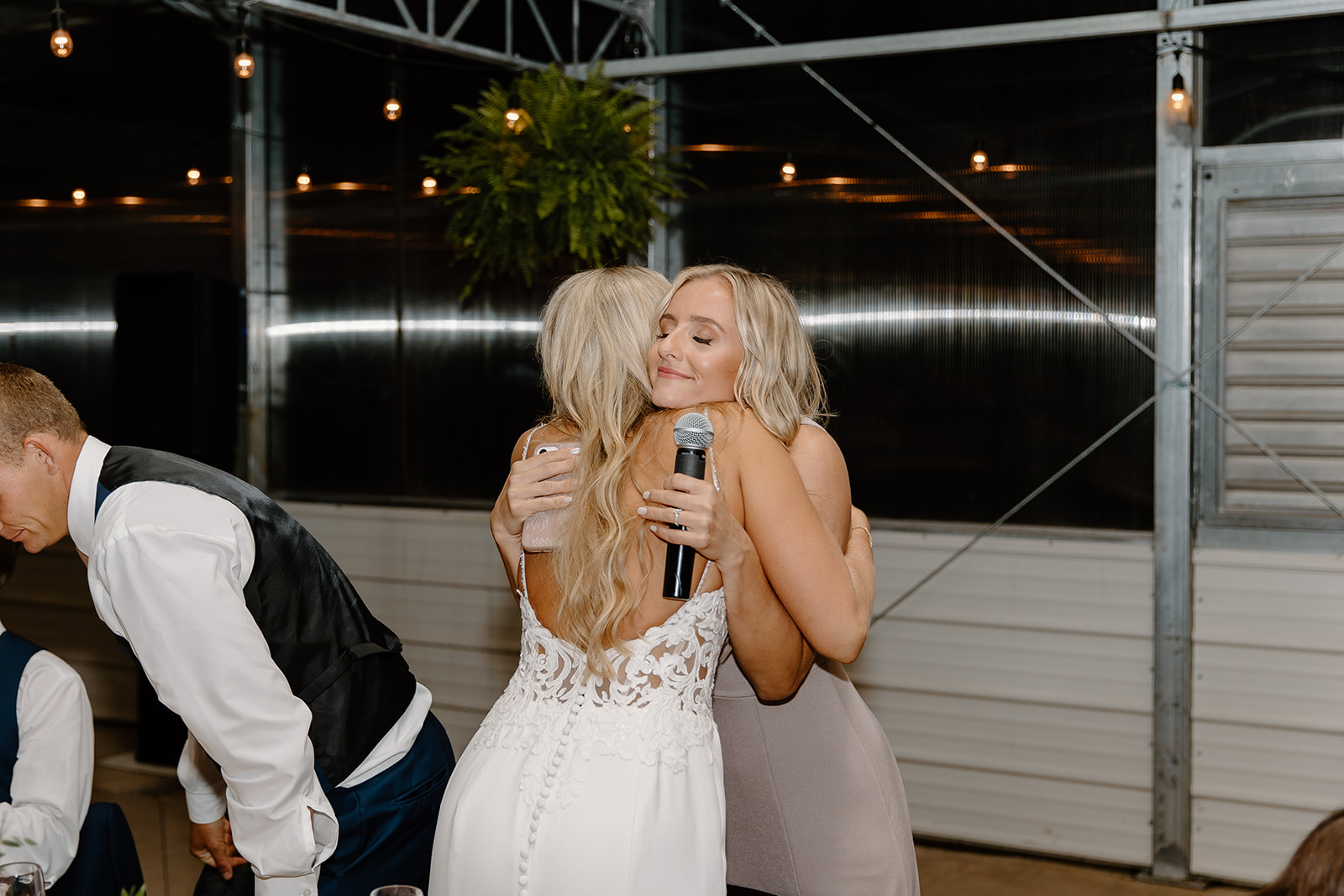 Bride hugs sister after speech at reception