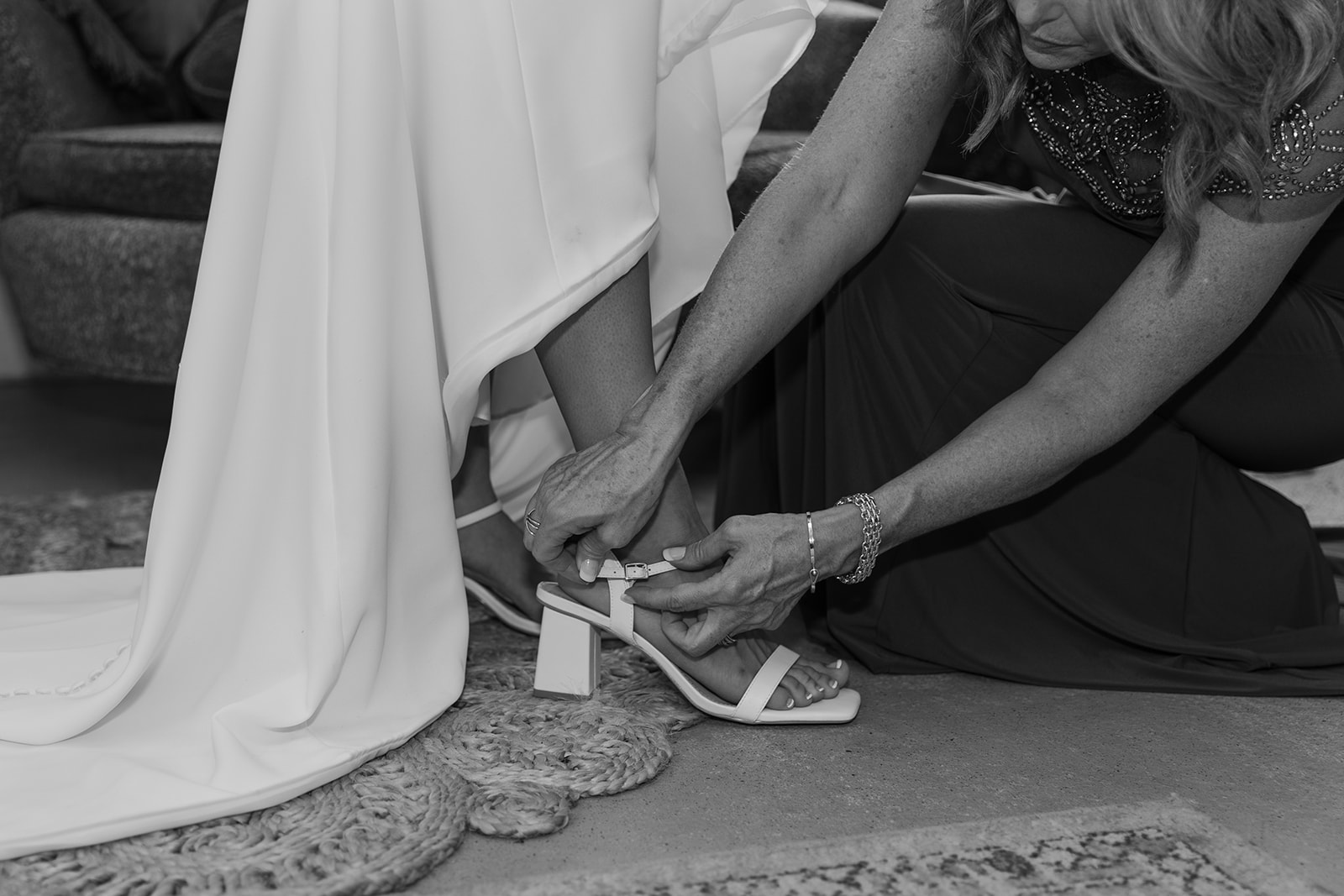 Mother puts on her daughter's wedding shoes