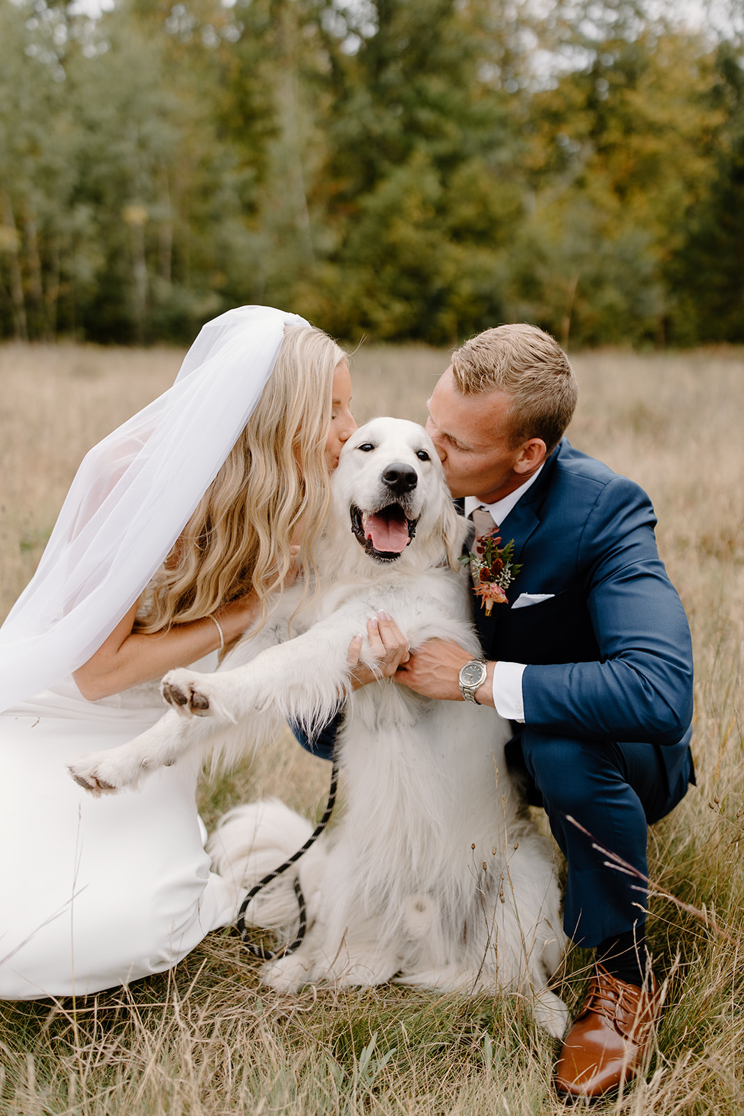 Bride and groom kiss their dog