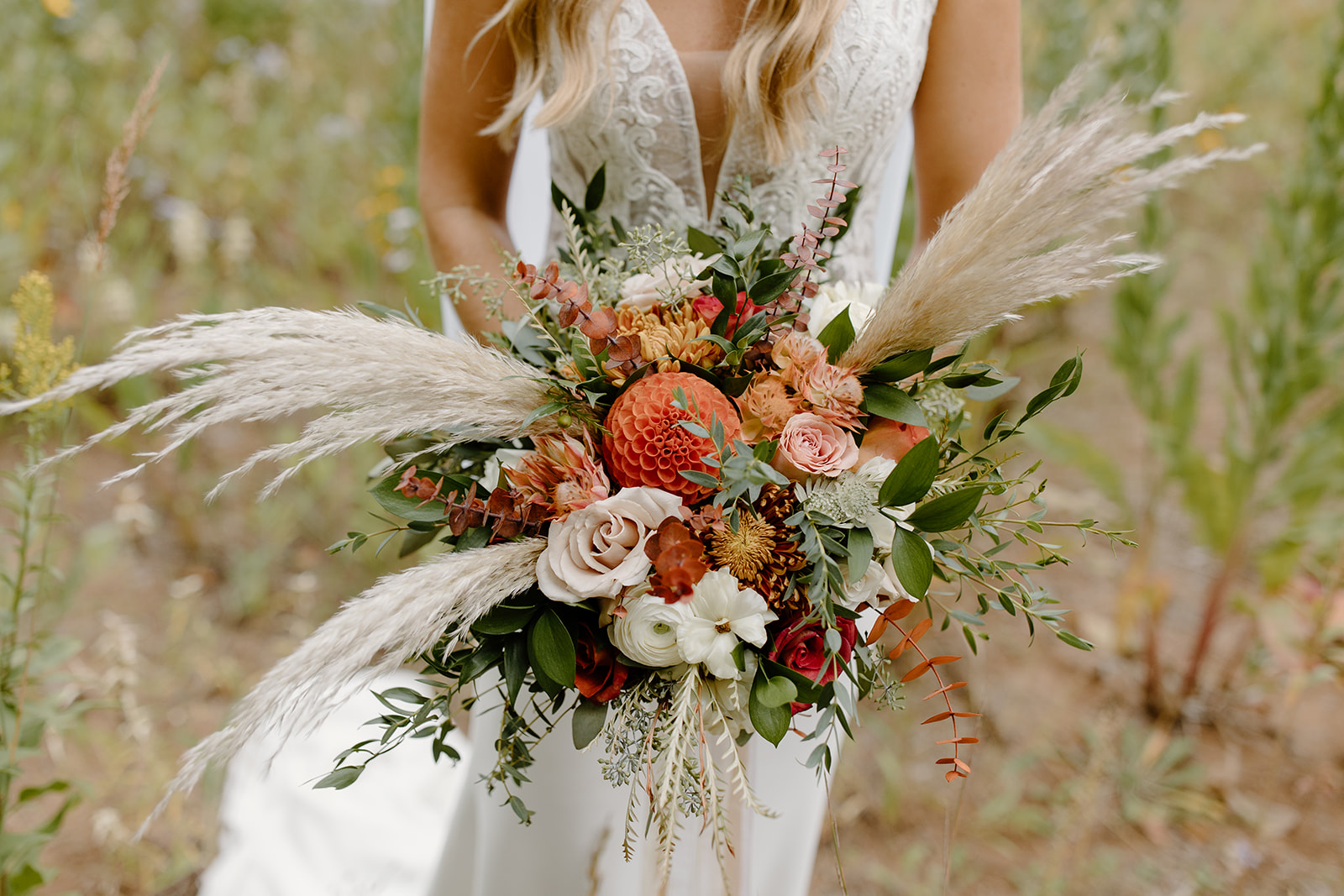 Bride holding her bouquet with pampas grass