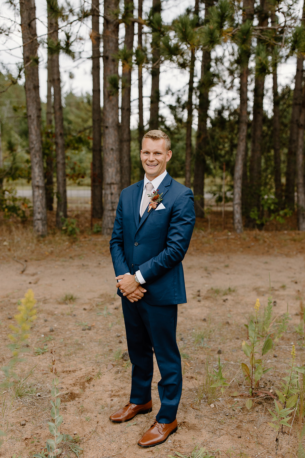 Groom smiles at the camera