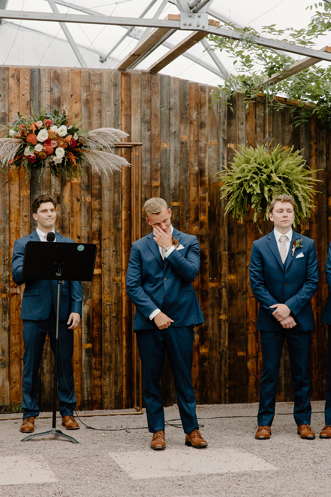 Groom cries at the end of an aisle