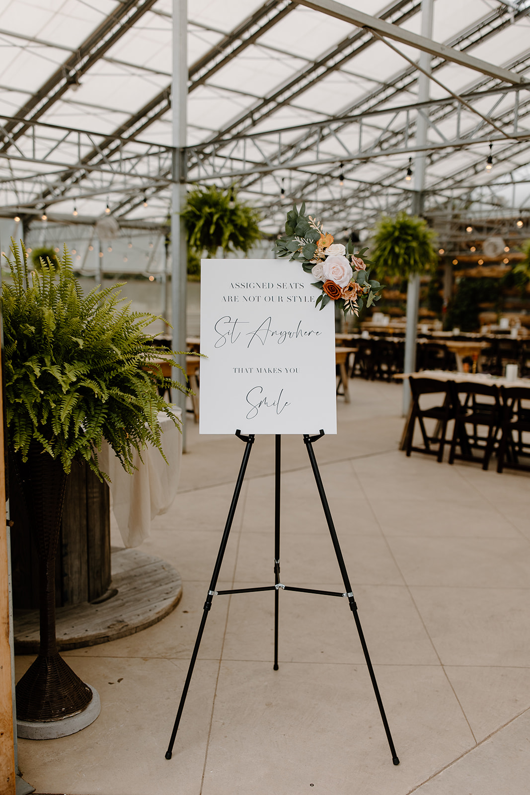 Wedding reception sign inside of a greenhouse