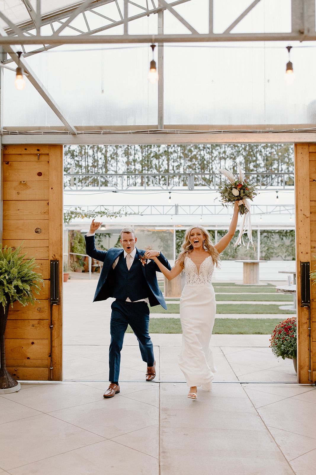 Bride and groom enter into their wedding reception