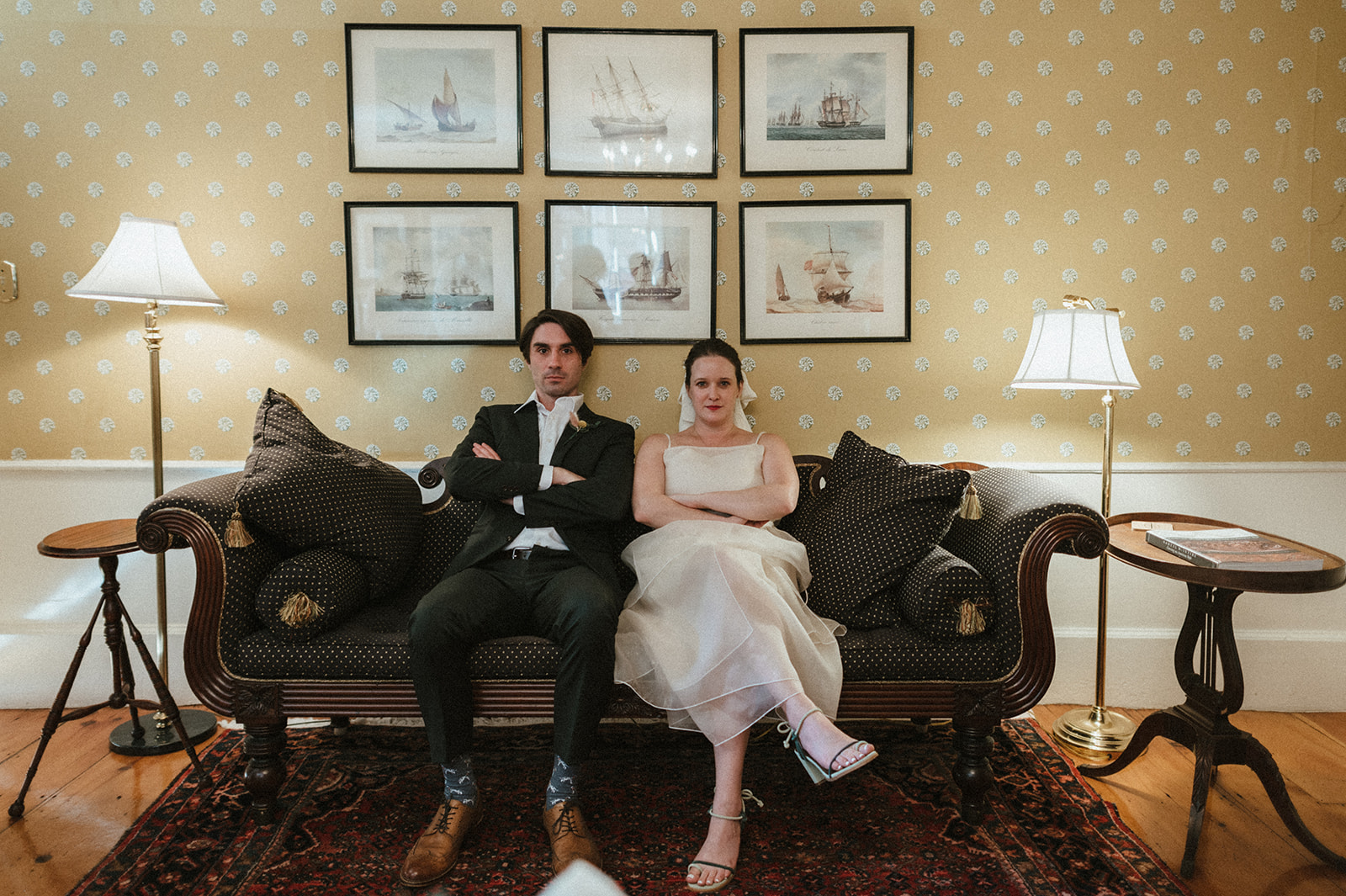 Bride and groom pose for portrait during Wes Anderson inspired wedding at Hamilton Hall in Salem Massachusetts