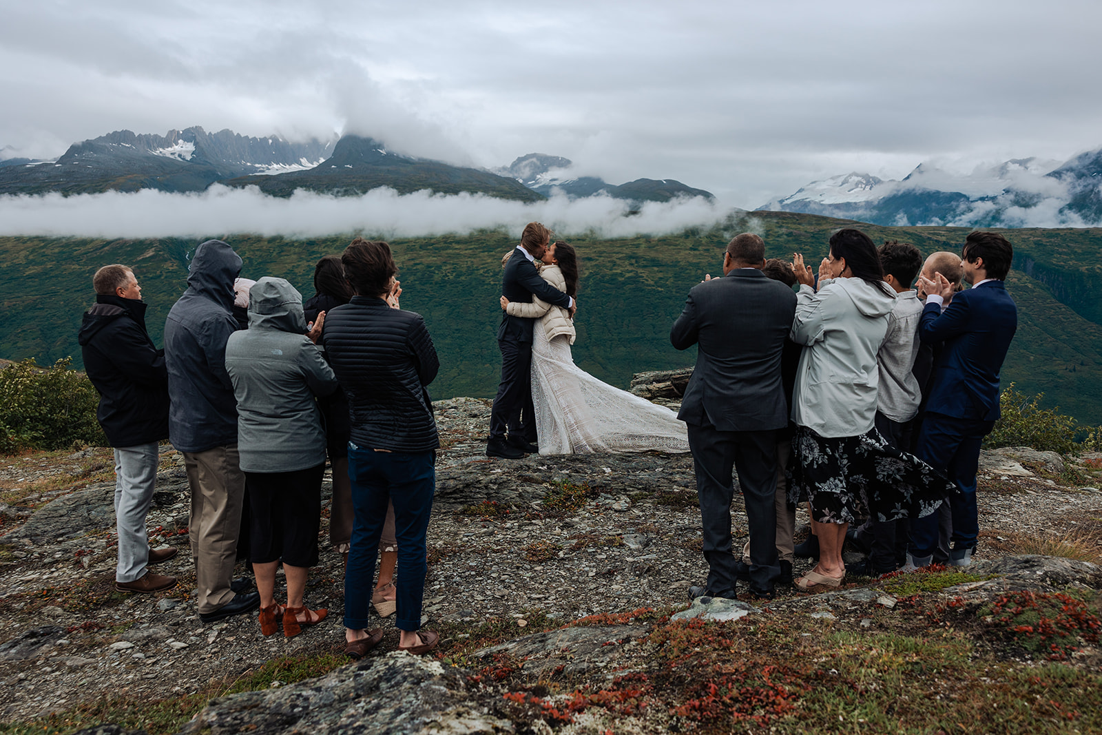 Couple has a small wedding ceremony on a mountain ridge in Alaska