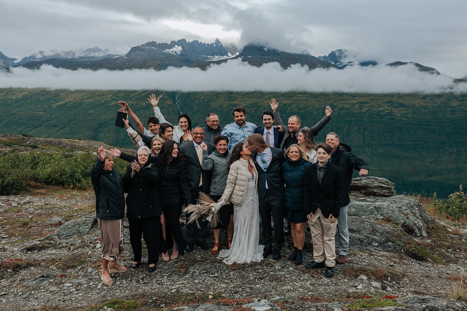 Couple has a small wedding ceremony on a mountain ridge in Alaska