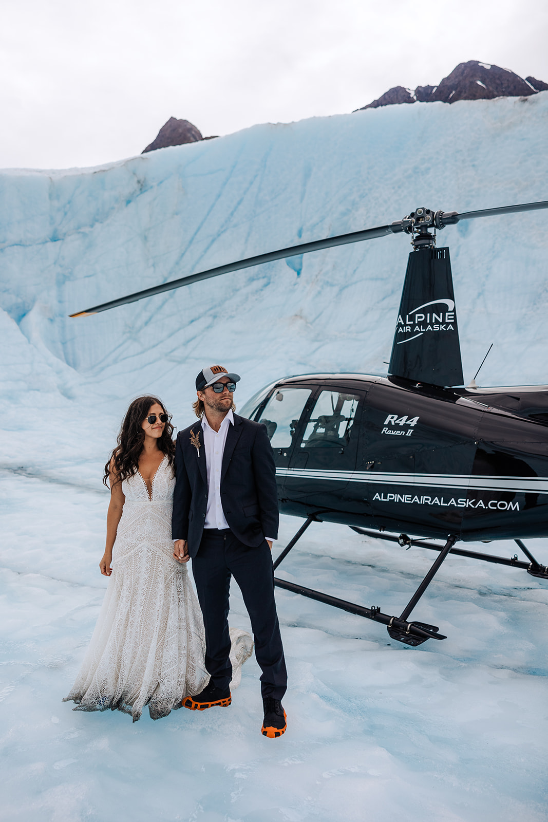 wedding couple flies in a helicopter for adventurous portraits in alaska