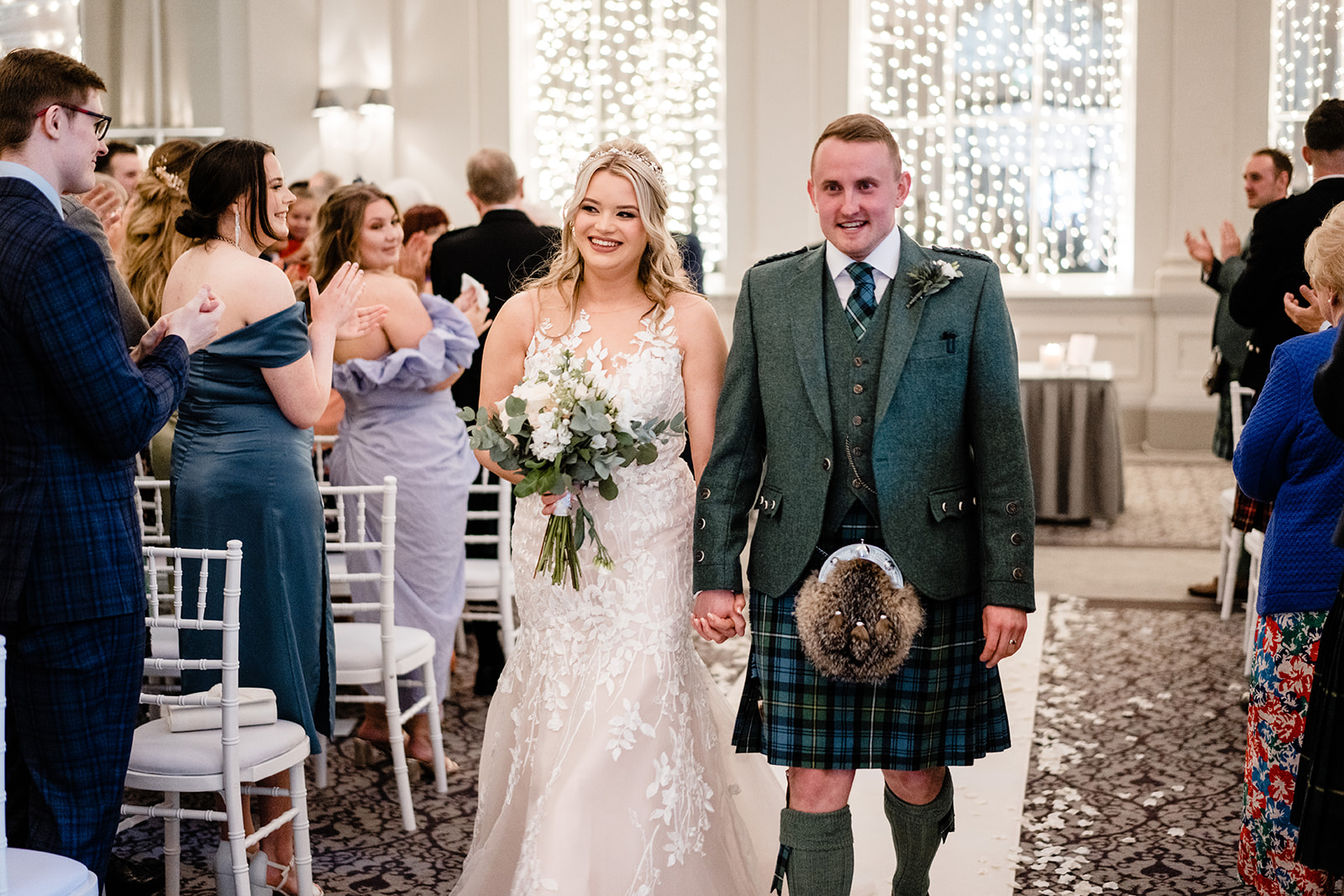 couple walking down the aisle at Edinburgh the George hotel after signing their marriage schedule