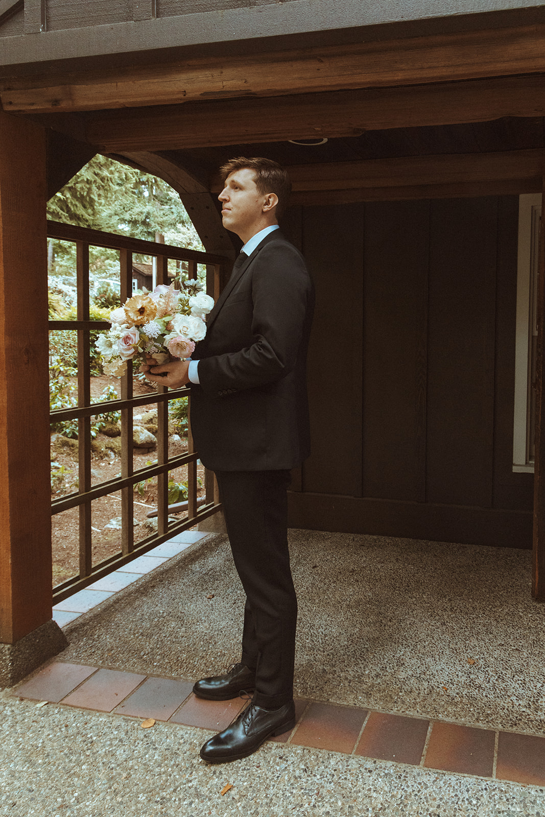 Groom waits with floral