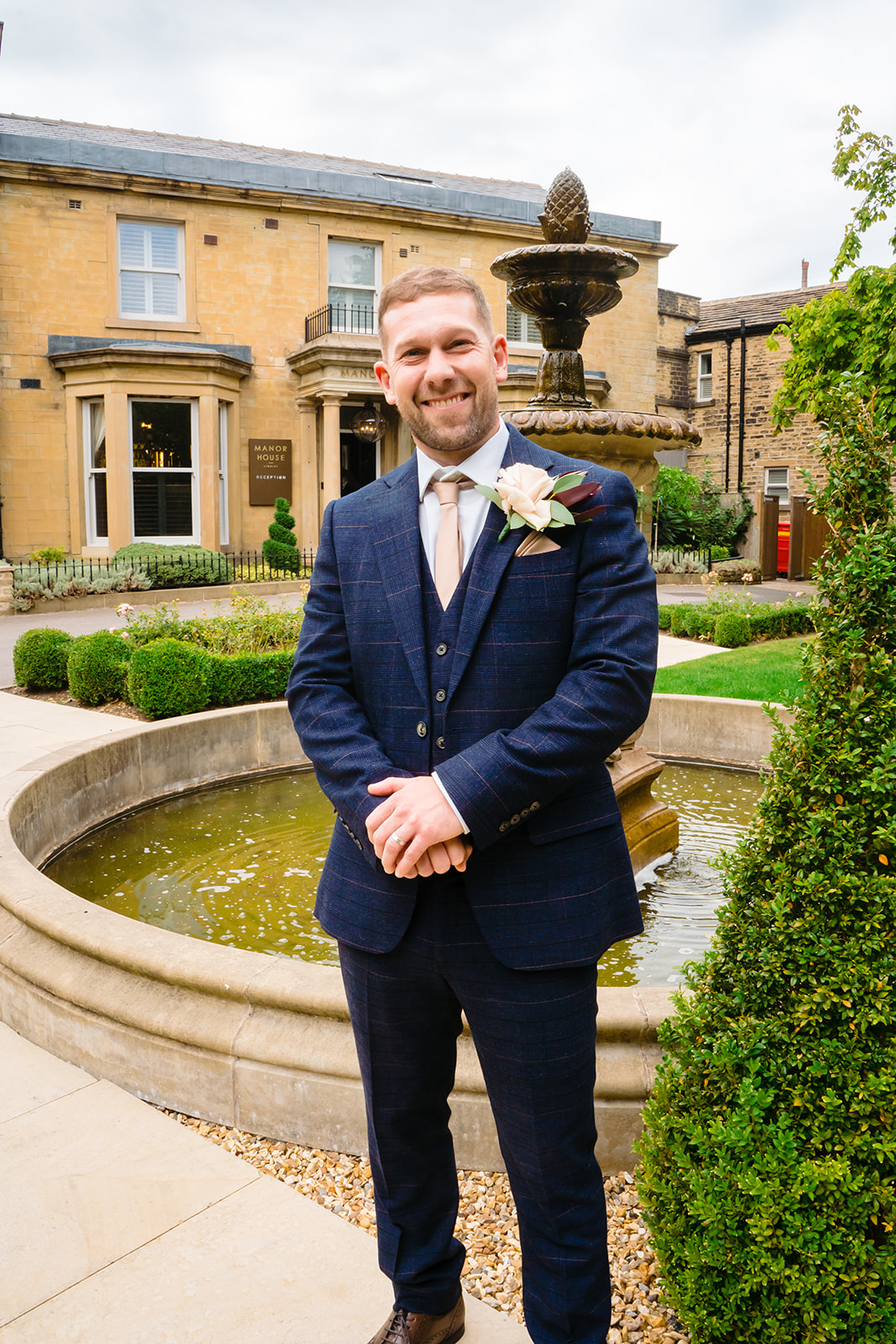 groom outside the front of manor house lindley