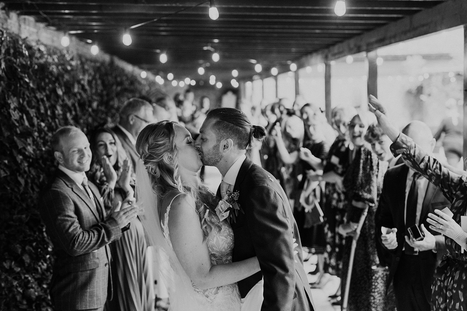 Black and white confetti shot kiss at Woodhall Manor by wedding photographer Martin Beale