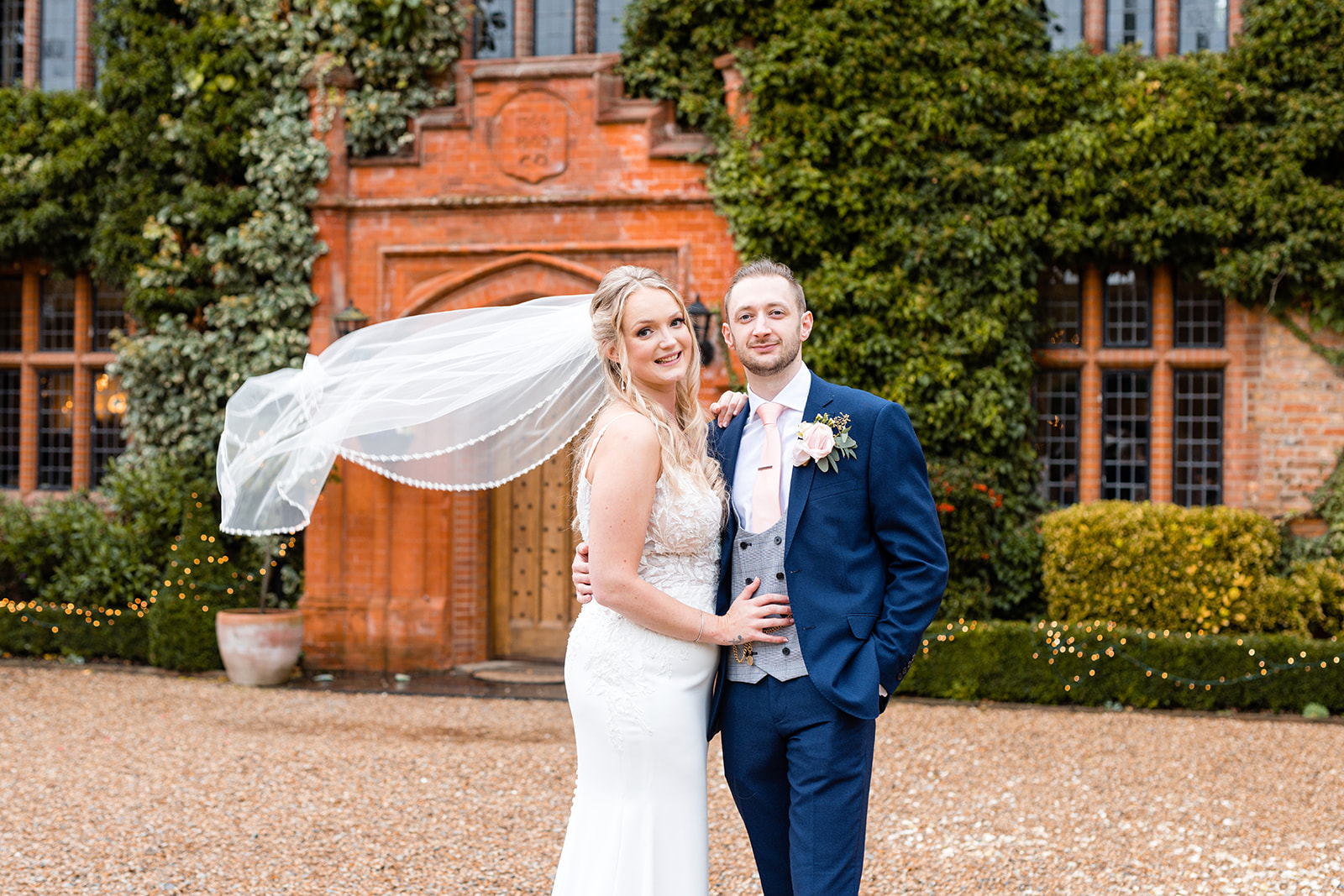 Beautiful couple stood in front of Woodhall Manor, Suffolk captured by Essex wedding photographer Martin Beale 