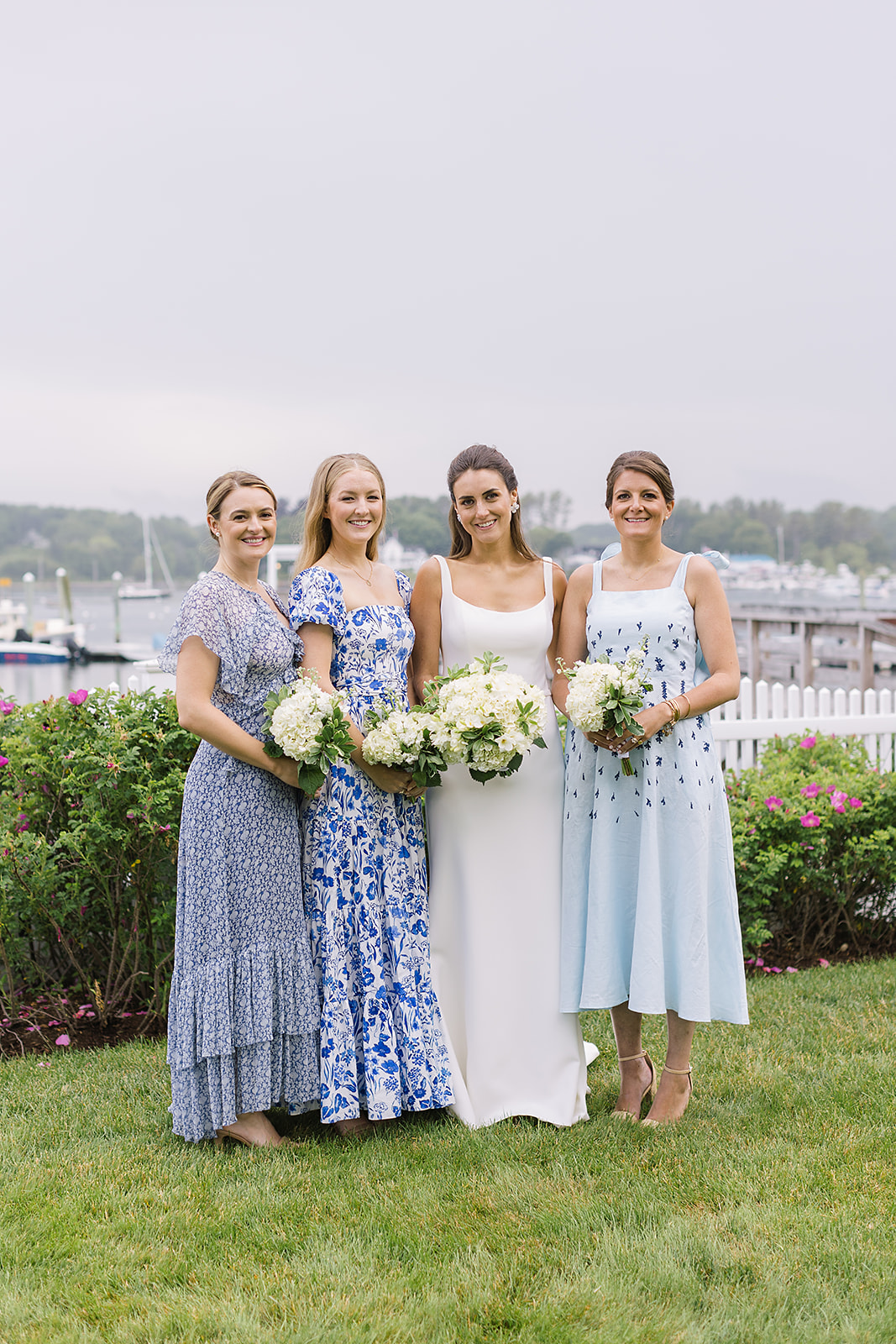 Clare and bridesmaids in mismatched dresses (including Reformation) before ceremony. Hair & Makeup by Le Glam Team.