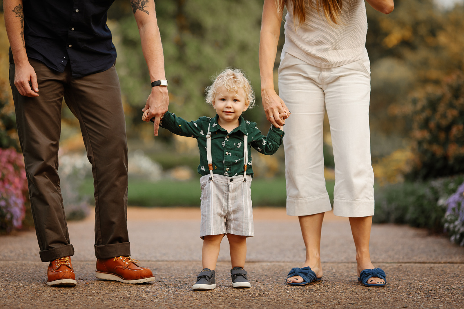 A sunset candid family session in Minneapolis with adorable little boy wearing suspenders.