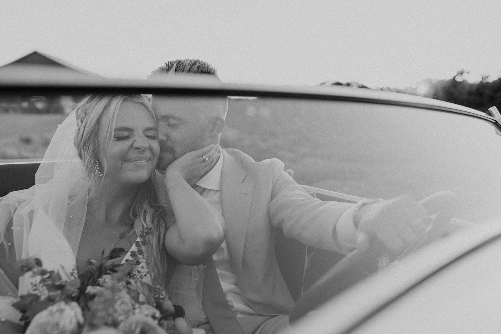 Golden hour photos of bride and groom in a beautiful classic car