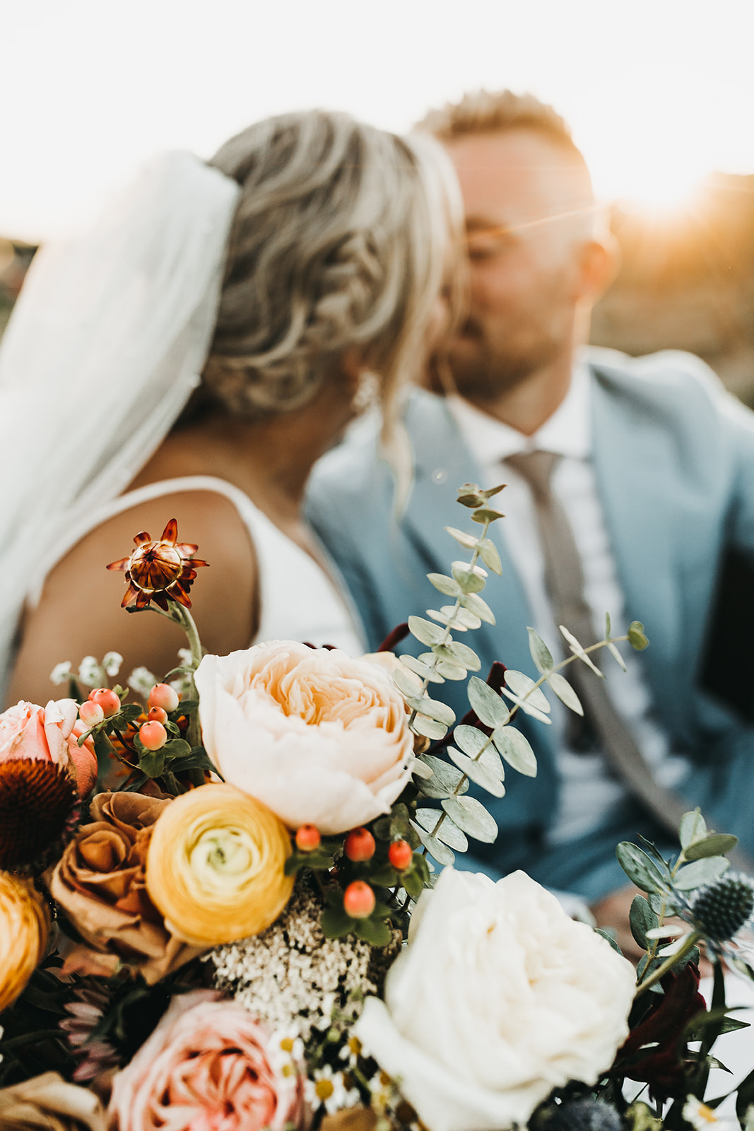 Golden hour photos of bride and groom sharing a special kiss