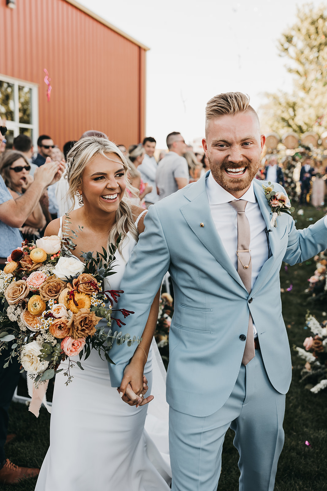 Bride and groom celebrate walking down the aisle together after saying I do