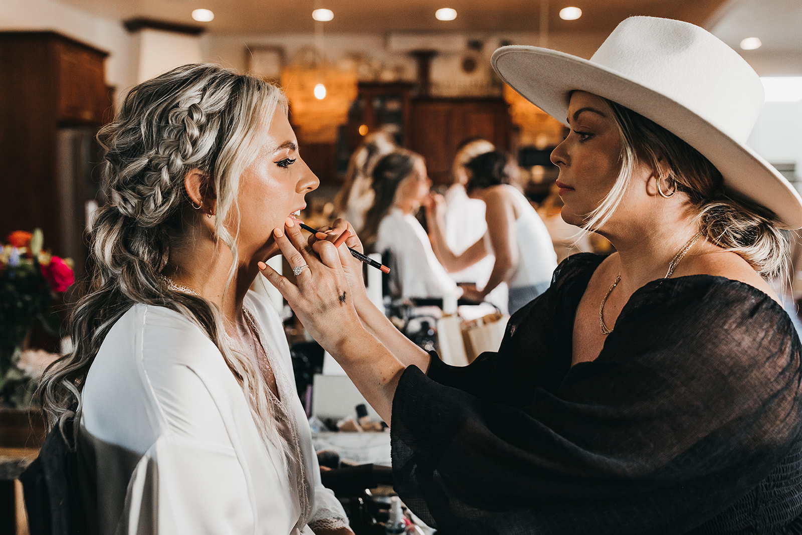 Bride getting makeup done for wedding