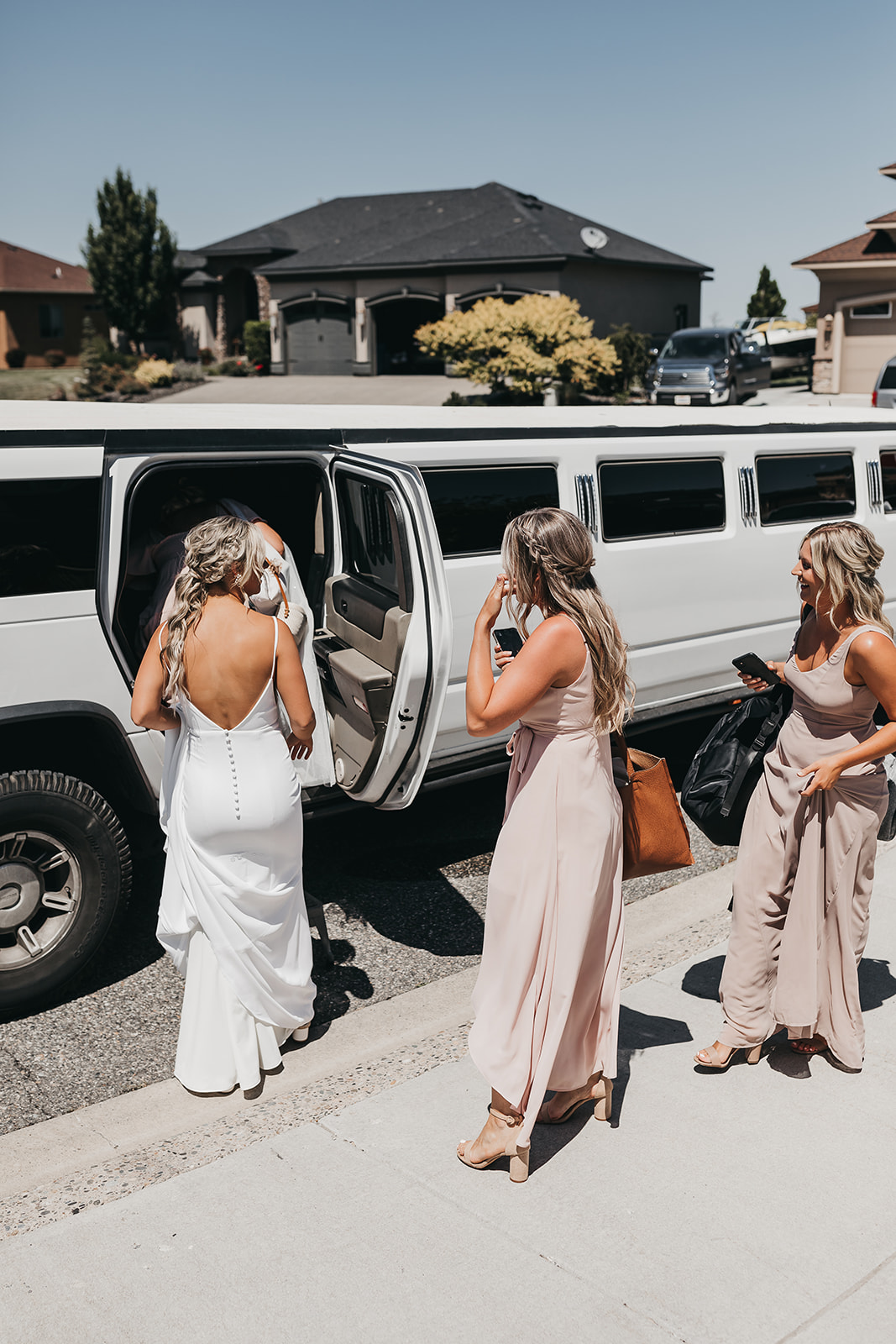 Bride and bridesmaids getting in limo to ride to Cooper Wine Company winery in Washington for wedding ceremony