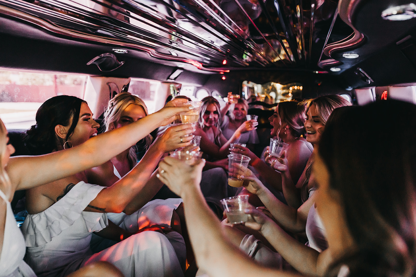 Bridal party sharing a toast in a limo taking them to wedding ceremony location at Cooper Wine Company wedding in WA