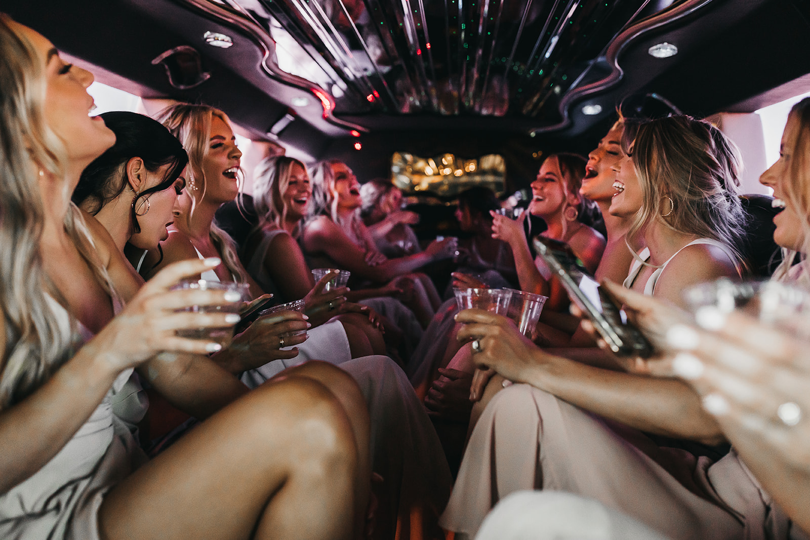 Bride and bridesmaids having fun in the limo ride to the wedding at Cooper Wine Company winery in Washington