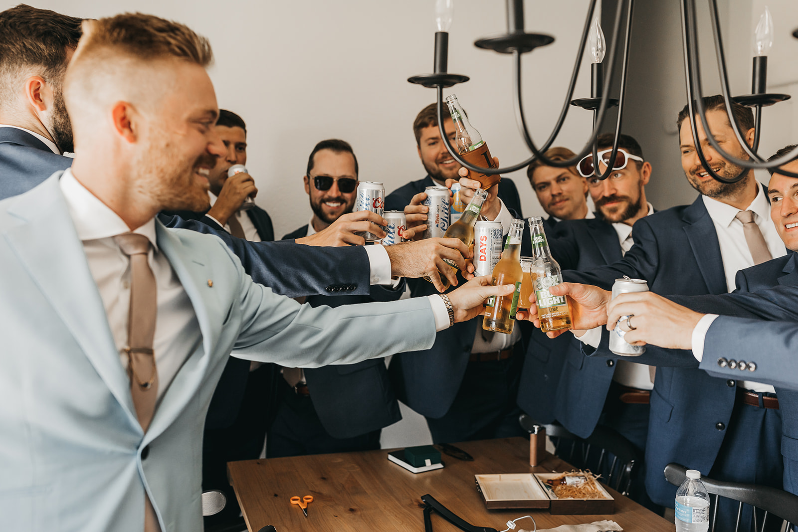 Groom and groomsmen sharing a toast and some beers before the wedding at Cooper Wine Company Washington