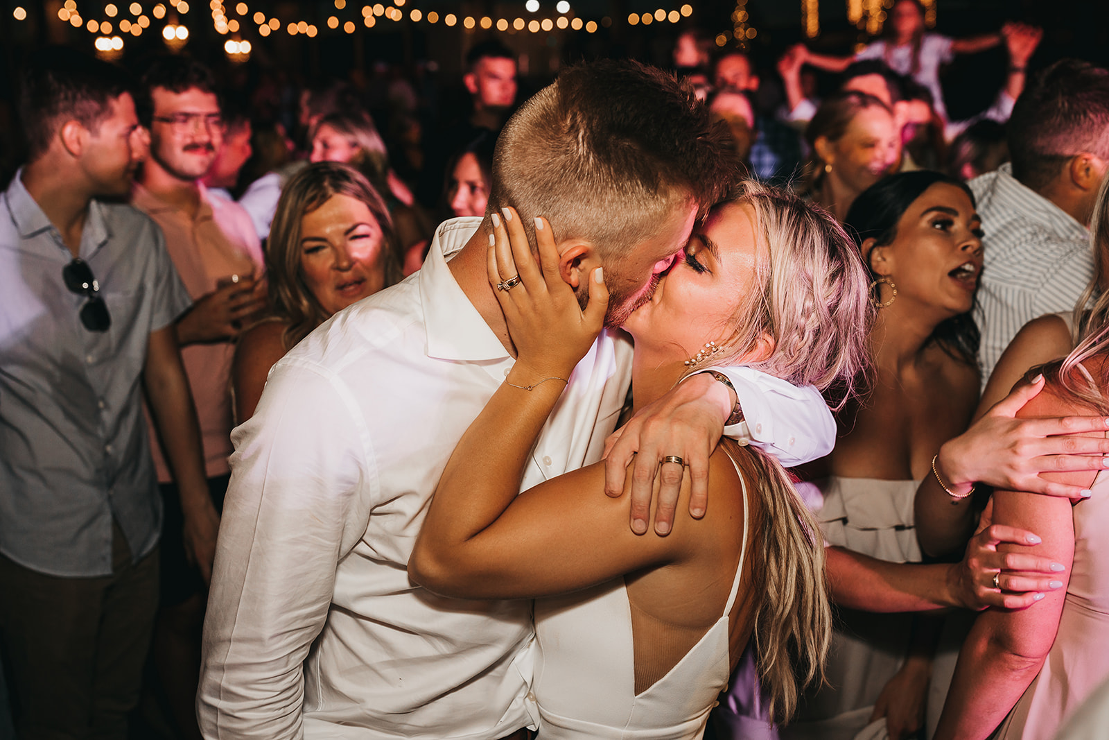 Bride and groom starting to party and have a blast at wedding reception and sharing a special kiss