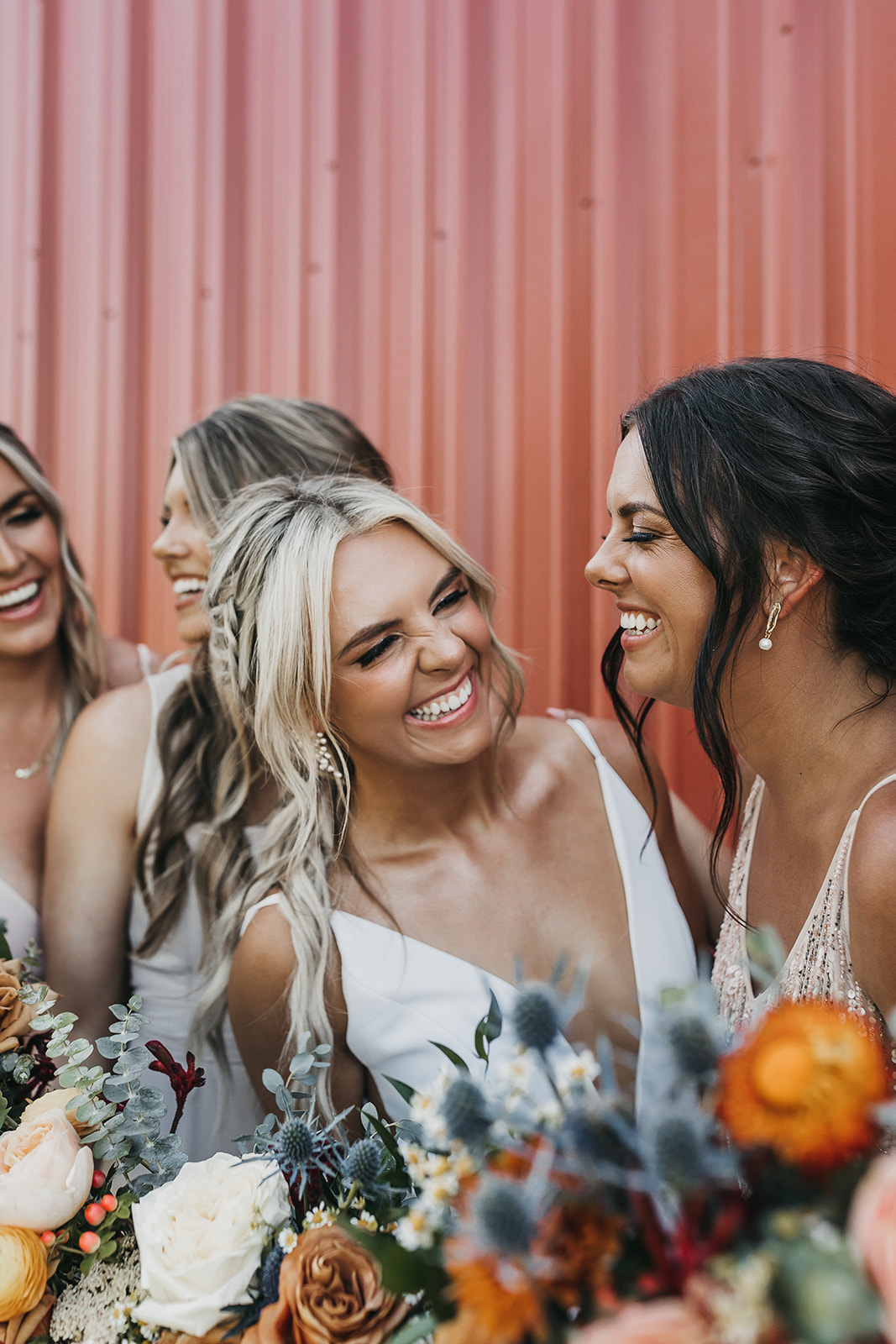 Bride and bridesmaid share a laugh before the wedding at Copper Wine Company winery
