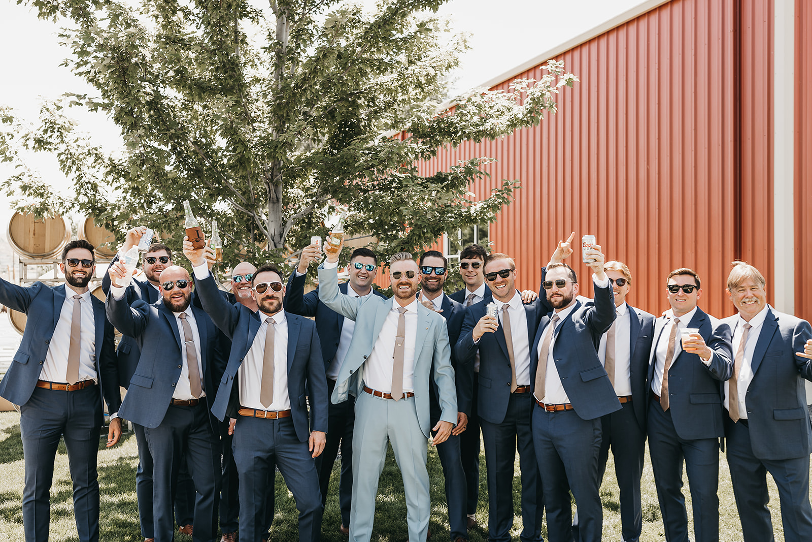Groom and groomsmen sharing a drink before the wedding  at Copper Wine Company winery