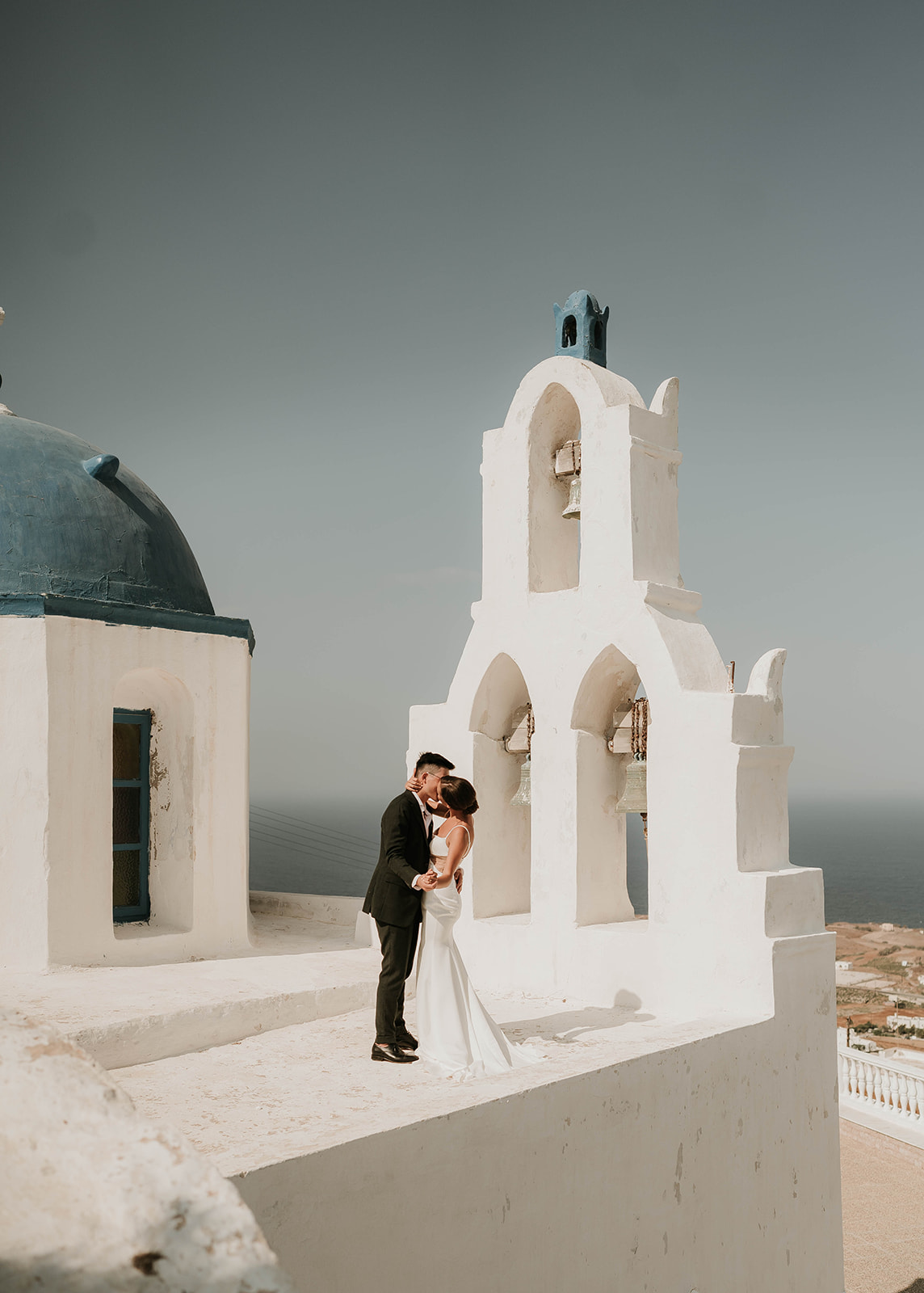  A couple who eloped in Santorini have their first dancing on church rooftop