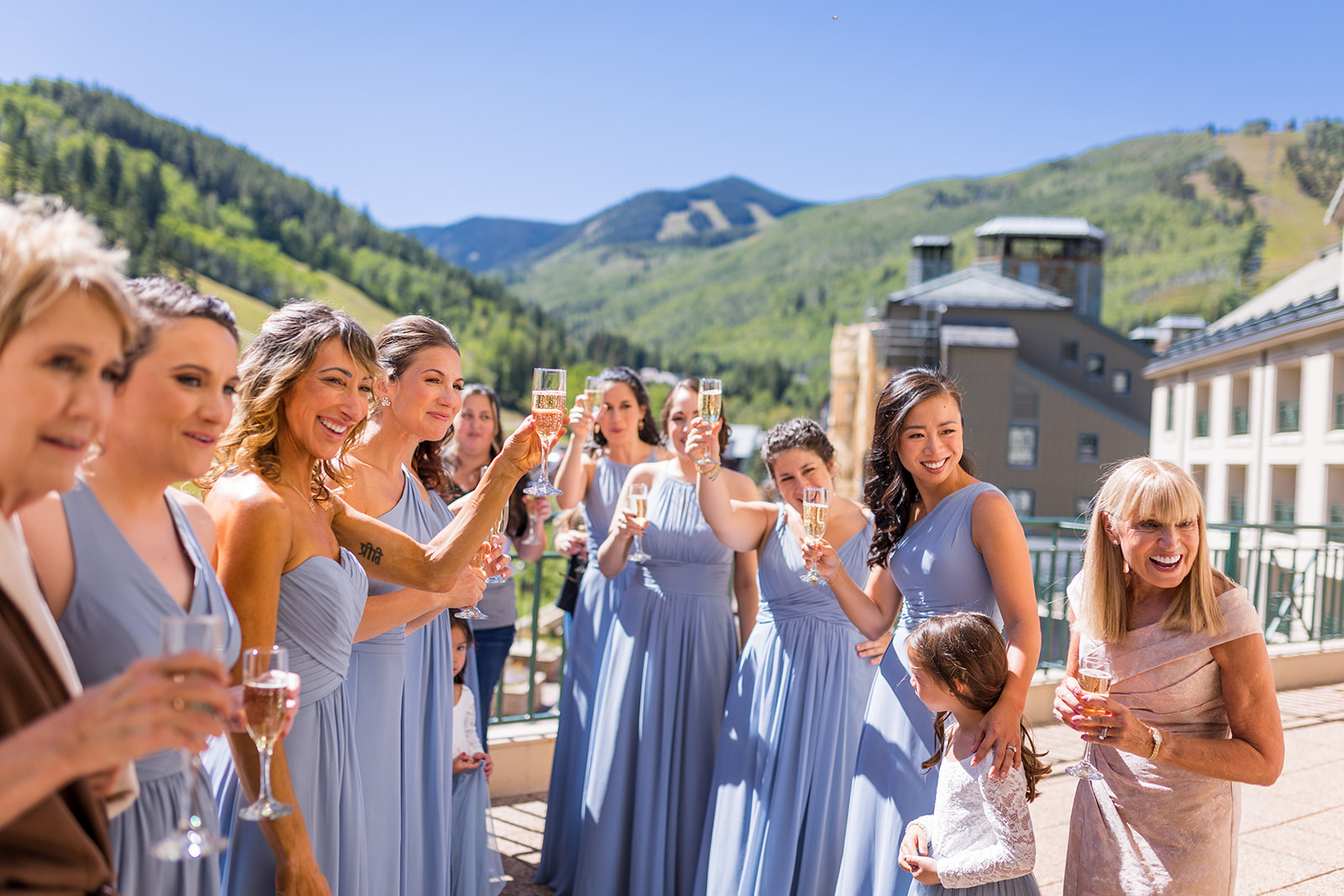 Bridesmaids celebrate with glasses of champagne.