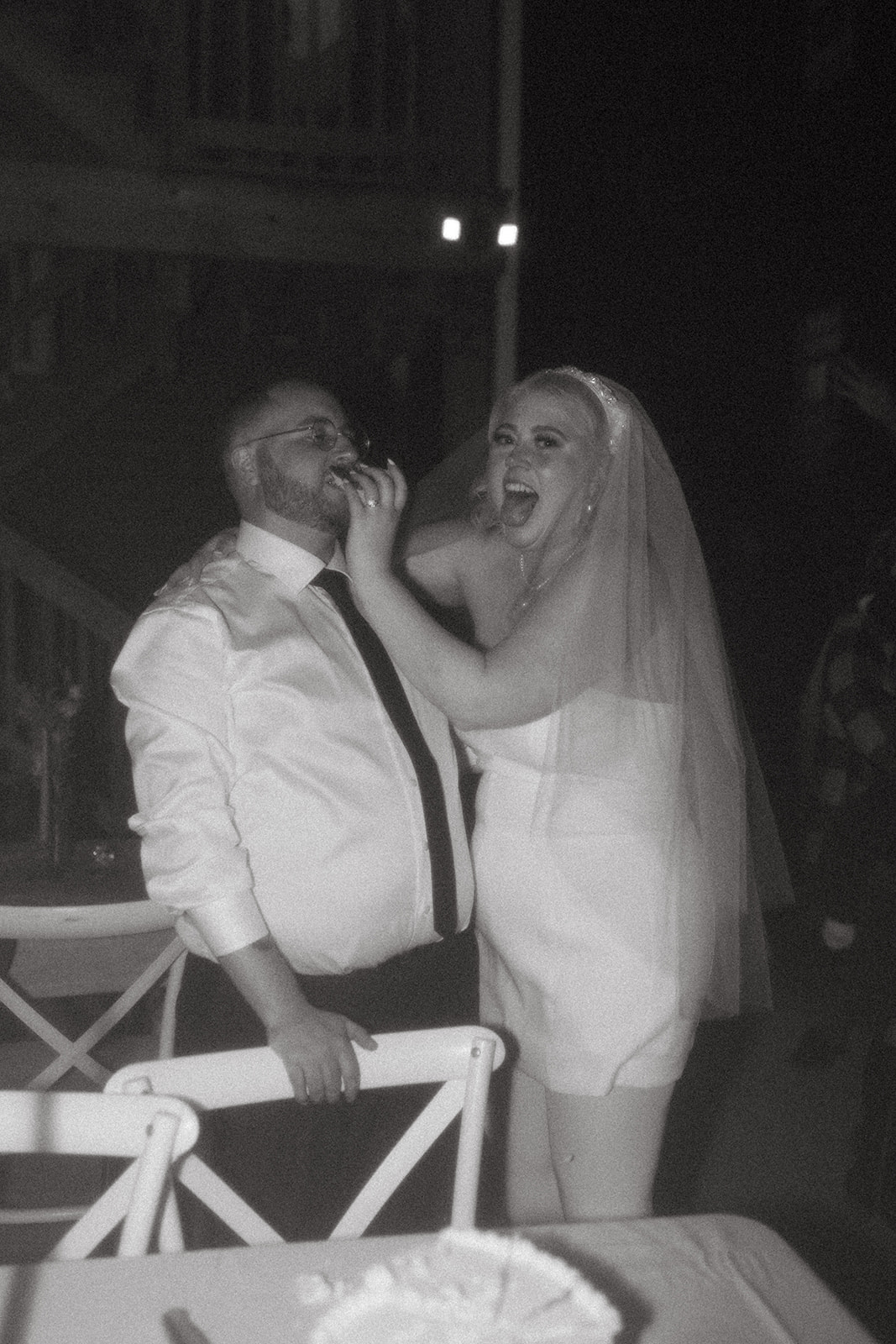 bride shoving cake in grooms mouth